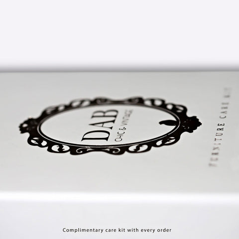 White rectangular box with black ornate logo for dab chic and vintage furniture care kit for handmade kitchen island