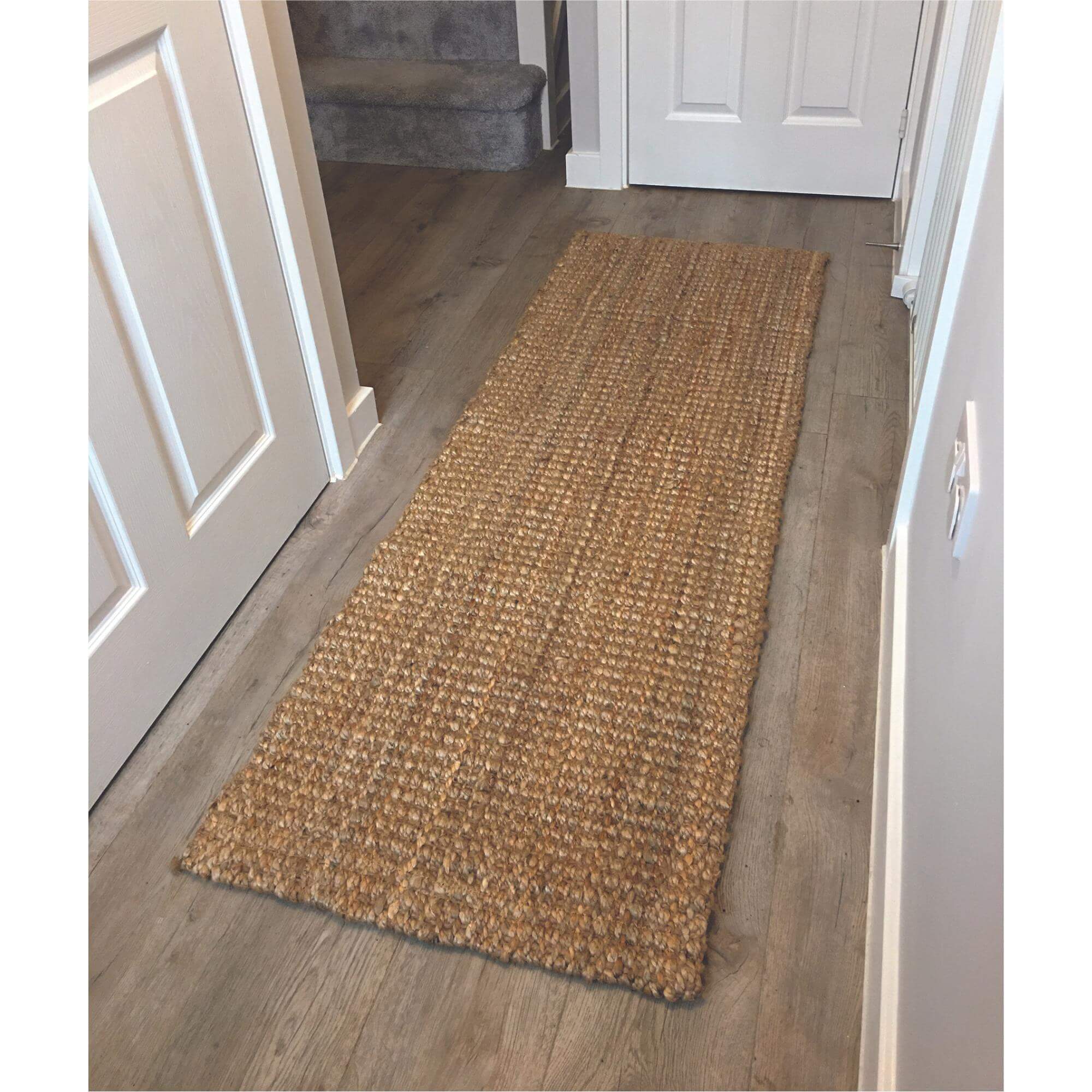 Handmade natural jute rug with a textured woven pattern in earthy beige tones perfect as a natural jute hallway runner