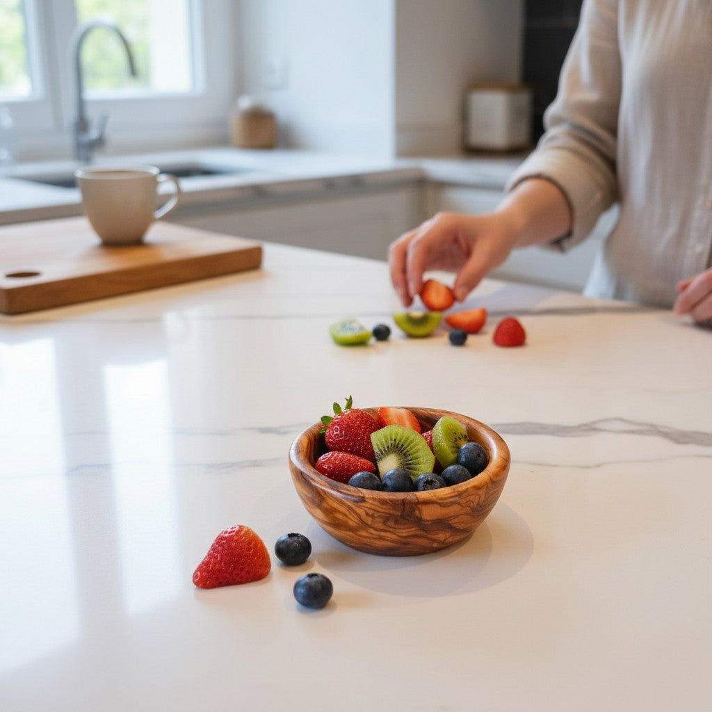 Handmade olive wood bowl with silky polished interior filled with strawberries kiwi and blueberries in working days size