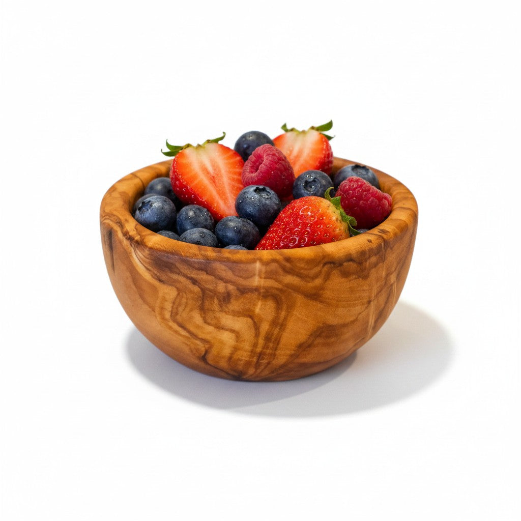Handmade olive wood bowl with a silky polished interior and warm swirling grain perfect for serving salad or fruit