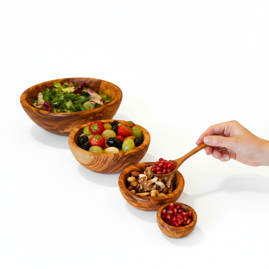 Set of four handmade olive wood bowls with silky polished interior and beautiful swirling natural grain in varying sizes