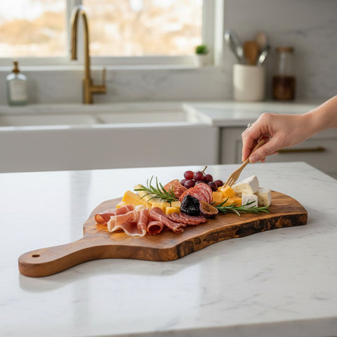 Handmade olive wood cutting board with live bark edge and handle perfect for rustic charcuterie and fruit serving
