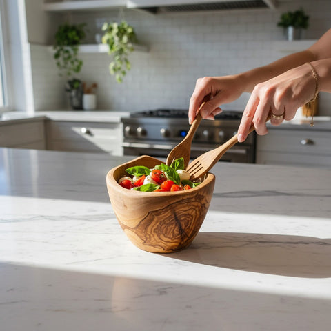 Handmade olive wood salad bowl with natural bark edge and swirling grain, perfect for fruit serving and mixing