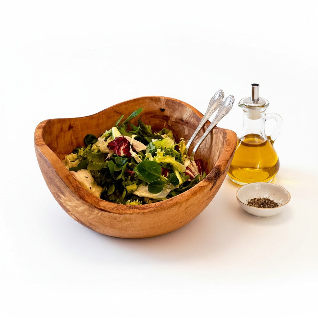Handcrafted olive wood salad bowl with unique natural bark edge filled with fresh greens and vegetables