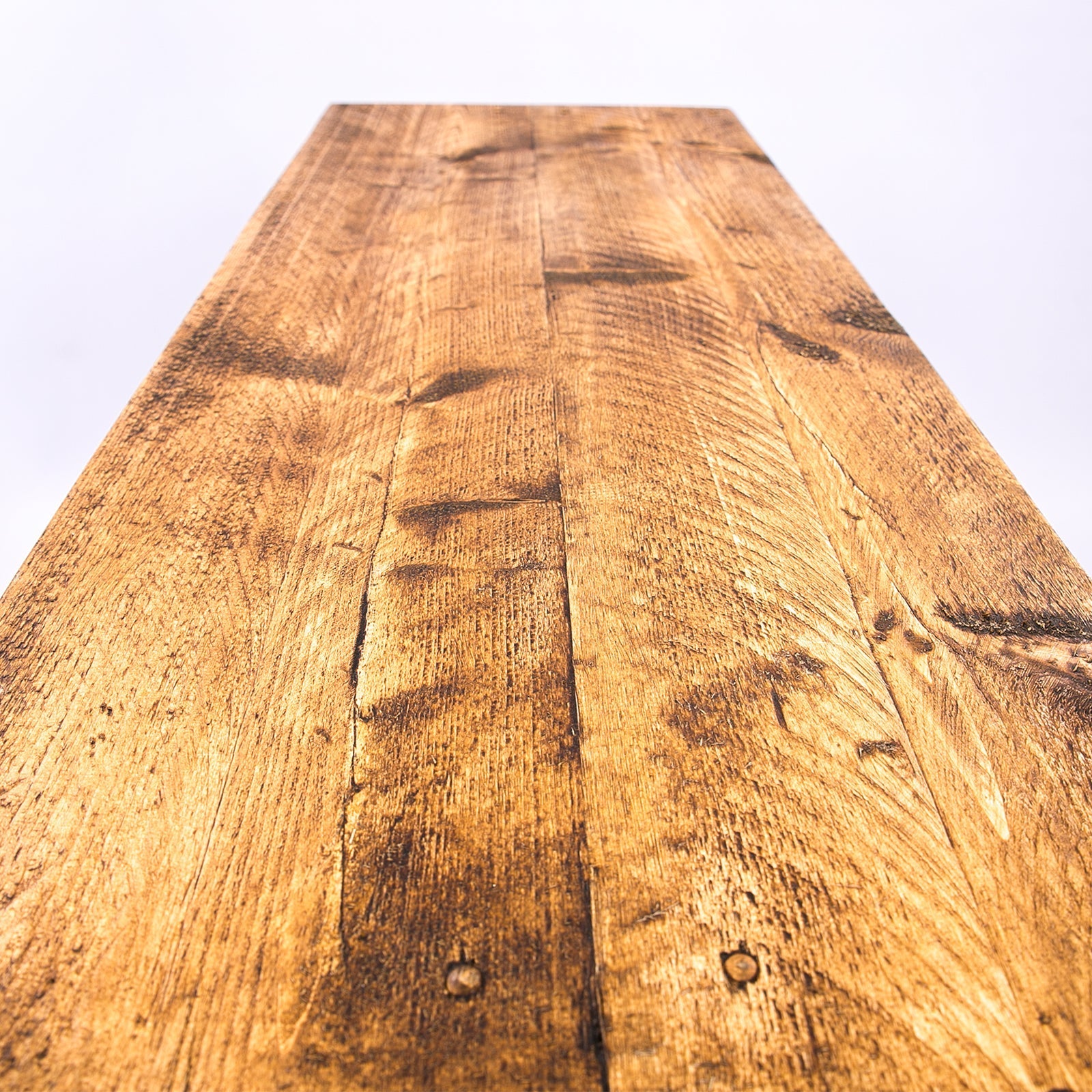 Handmade rustic tv stand with reclaimed wood plank warm finish black metal legs and visible grain patterns