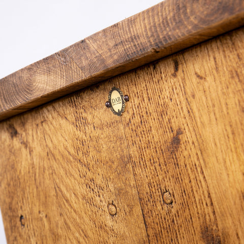 Handmade rustic tv stand with a medium brown wooden chest featuring natural grain and black metal legs