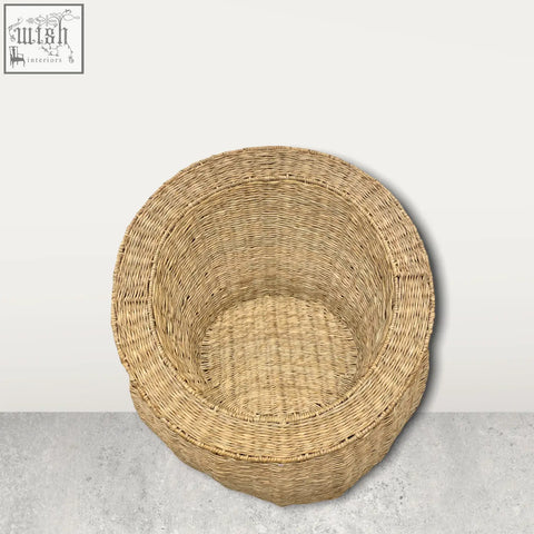 A round natural beige handwoven palm leaf chair made of tightly interlaced strands from mozambique