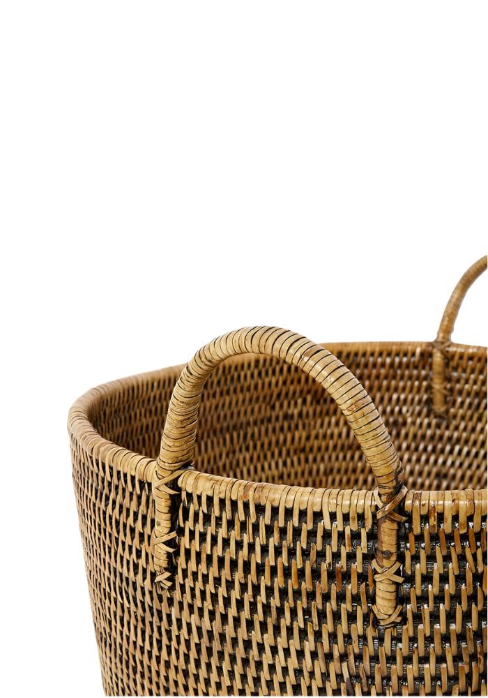 Handy handwoven rattan basket in brown with sturdy curved handles made of natural woven rattan material
