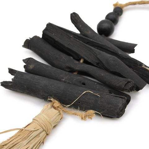 Hanging driftwood tassel 42cm featuring black charcoal sticks tied with natural twine and wooden beads