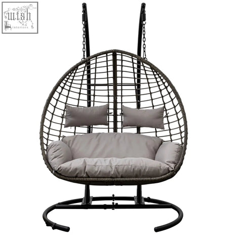 Black woven wicker hanging swing egg with gray cushions and pillows on power coated steel frame swing egg sofa