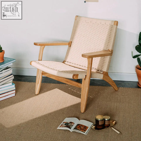 A hans ch25 oak armchair with a light oiled oak frame and woven natural cord seat and backrest