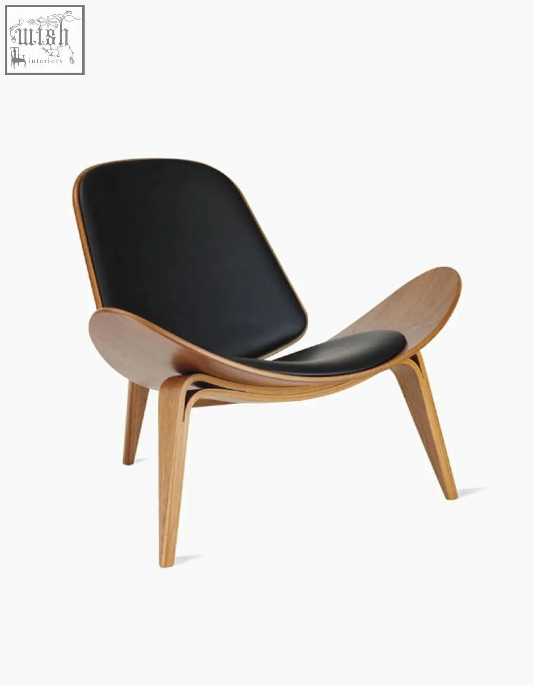 Elegant ch07 shell chair with black leather seat and backrest supported by light walnut wood curves and tapered legs