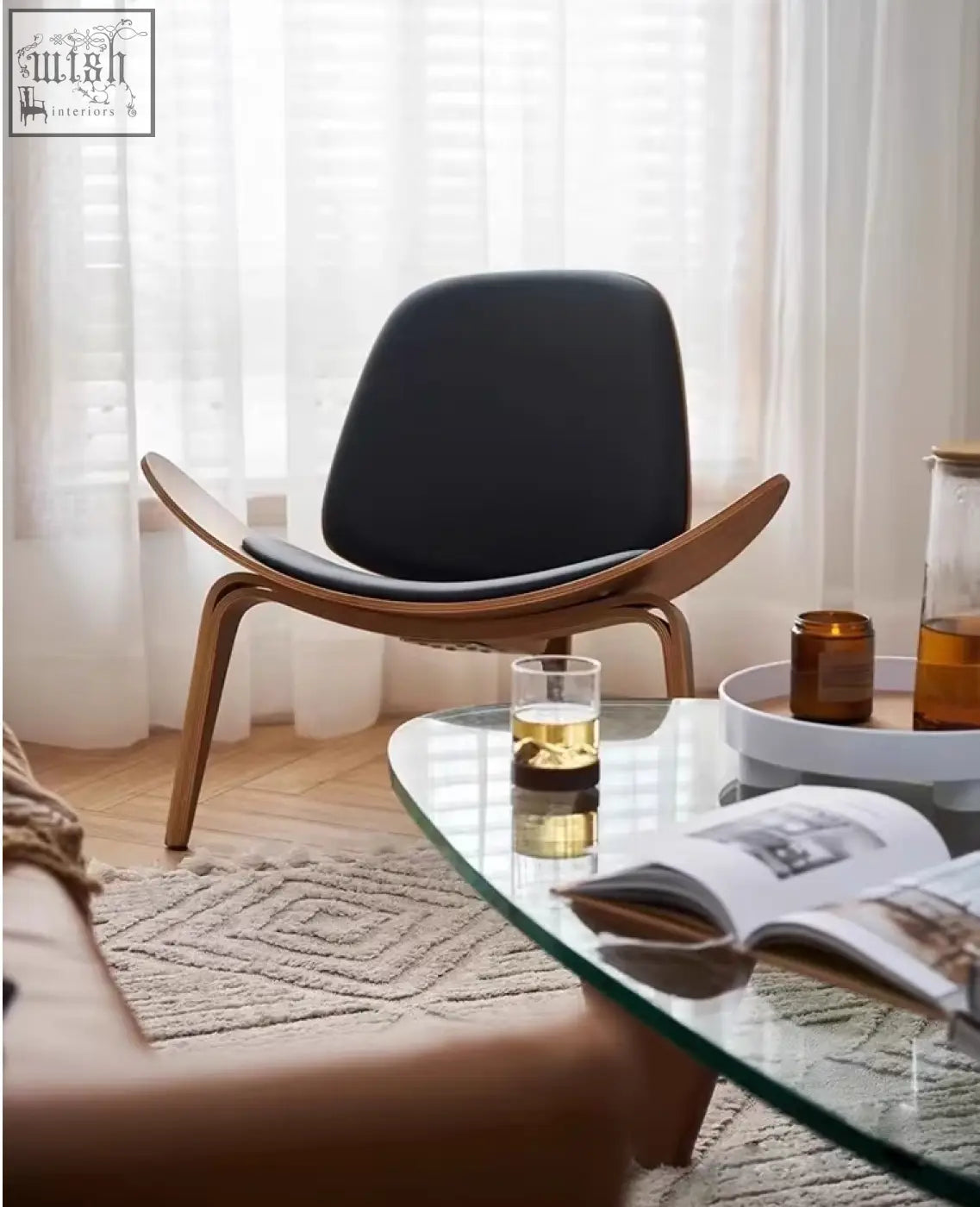 Black leather upholstered hans wegner ch07 shell chair with curved walnut wooden frame for stylish seating