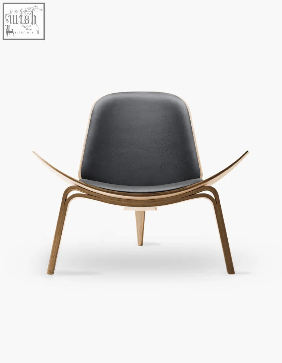Hans Wegner CH07 shell chair with sleek black leather seat and backrest on curved walnut wooden legs