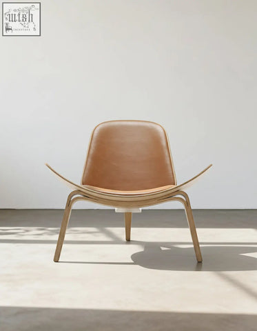 Tan leather hans wegner ch07 shell chair with curved oak wooden frame and legs for stylish seating