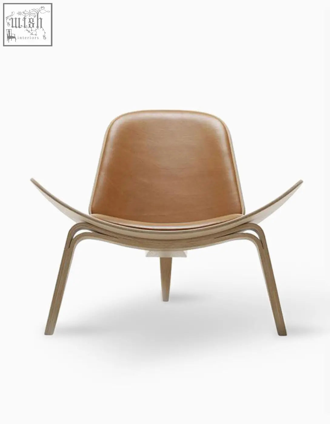 Tan leather upholstered hans wegner ch07 shell chair with sleek curved oak wooden frame in brown and oak finish