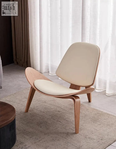 Cream-colored hans wegner armchair with curved white ash frame in light oak finish for stylish lounging