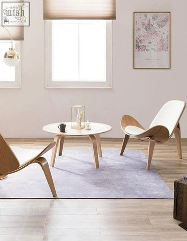 Modern hans wegner armchair with white ash frame and white upholstered seat in a sleek curved shell design