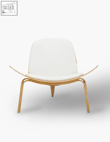 A hans wegner ch07 shell chair with sleek white upholstery and curved oak frame with tapered legs