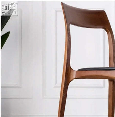 A hans wegner ch3 dining chair in dark oak with a sleek wooden frame and black upholstered seat perfect for dining chairs