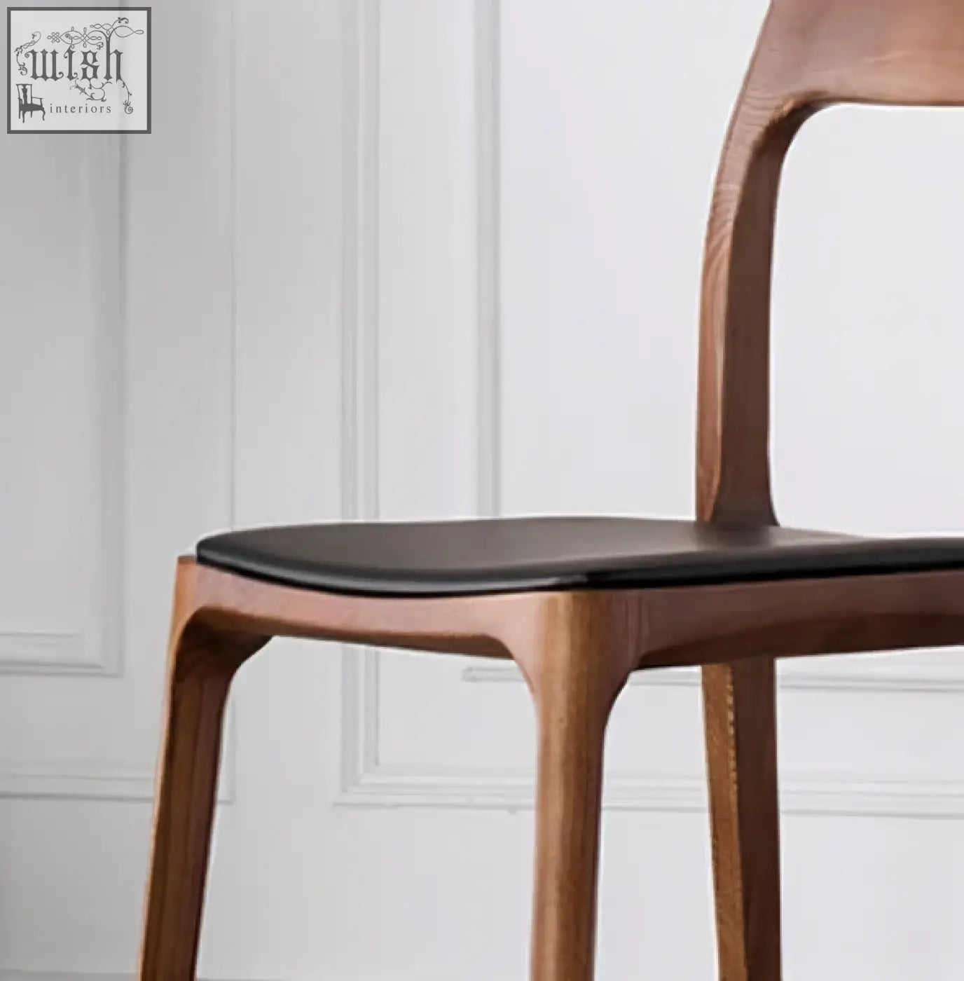 A hans wegner ch3 dining chair in dark oak with a sleek wooden frame and black upholstered seat perfect for dining rooms