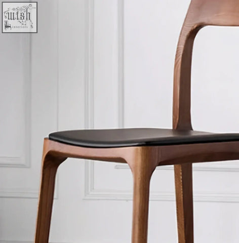 A hans wegner ch3 dining chair in dark oak with a sleek wooden frame and black upholstered seat perfect for dining rooms