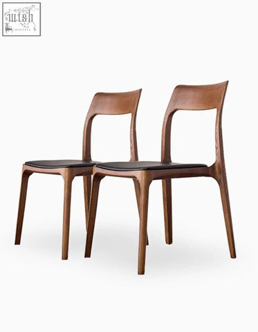 Two sleek hans wegner ch3 dining chairs in dark oak with black leather seats perfect for stylish dining rooms