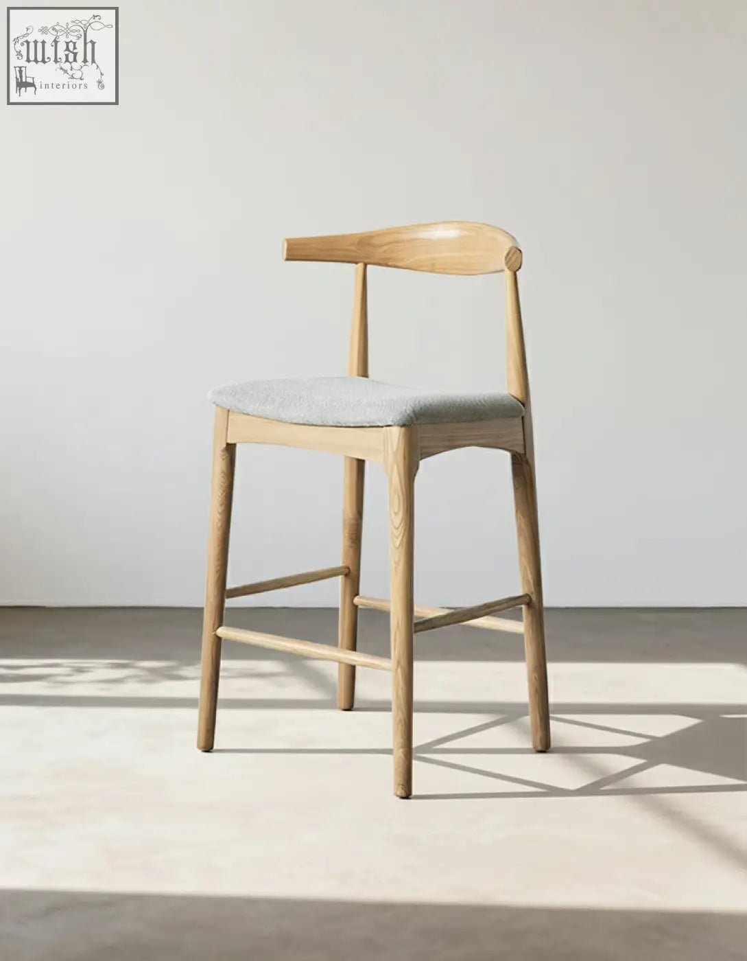 Light wood hans wegner ch32 bar stool with gray linen upholstered seat and curved backrest in oak rosewood
