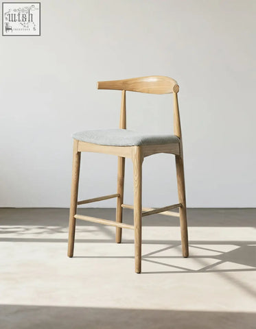 Light wood hans wegner ch32 bar stool with gray linen upholstered seat and curved backrest in oak and rosewood