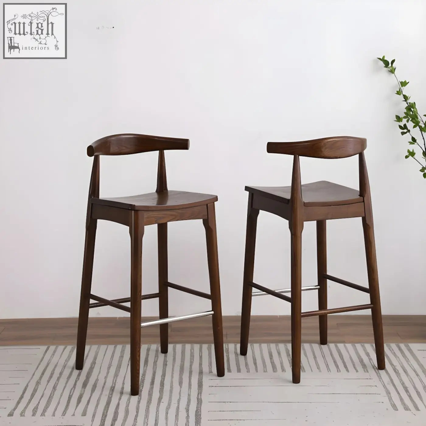 Two dark brown hans wegner ch32 bar stools with oak frame, rosewood seats, linen cushions, and metal footrests