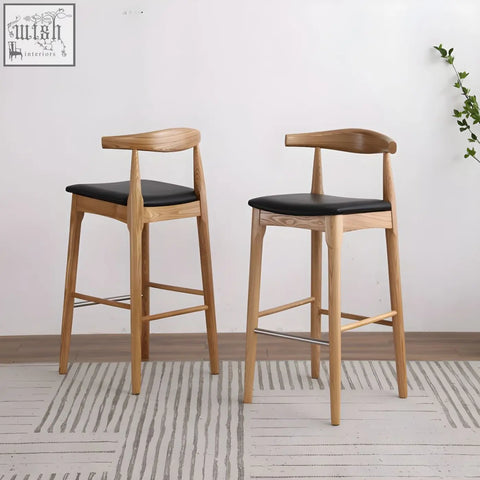 Two minimalist hans wegner ch32 bar stools with oak frames black leather seats and curved backrests