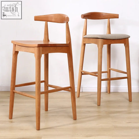 Two hans wegner ch32 bar stools in oak with light wood finish one with gray upholstered seat and linen rosewood legs