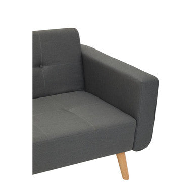 Gray upholstered armchair with wooden legs next to a grey linen corner sofa bed in hansa hagen style