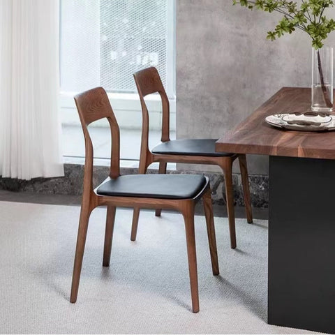 Modern hansel ch3 solid wood dining chair in dark oak with curved backrest and black leather seat