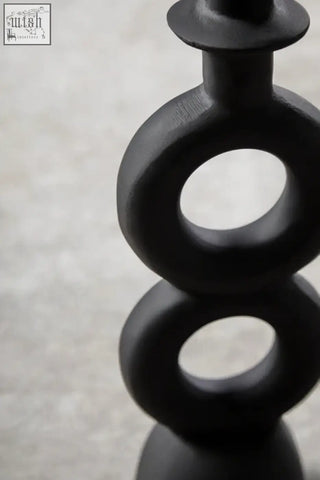 Black ceramic candle holder with stacked ring shapes in matte black perfect for large black candle display