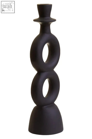 Large black ceramic candle holder with stacked circular rings and a matte black top hat-like finial for candles
