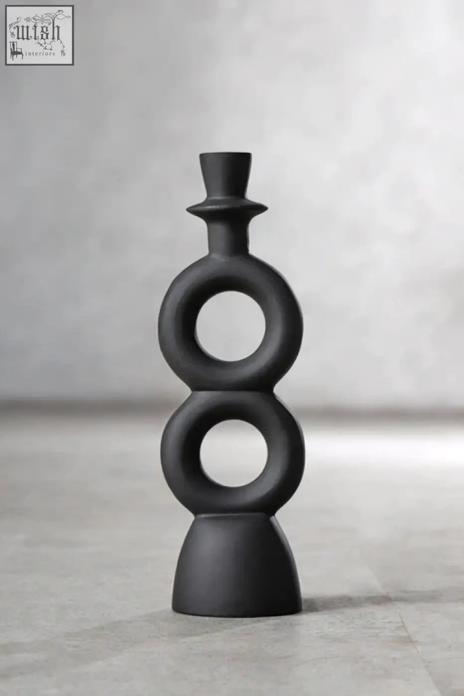 Black matte ceramic candle holder with stacked circular rings and top hat finial perfect for large black candle use