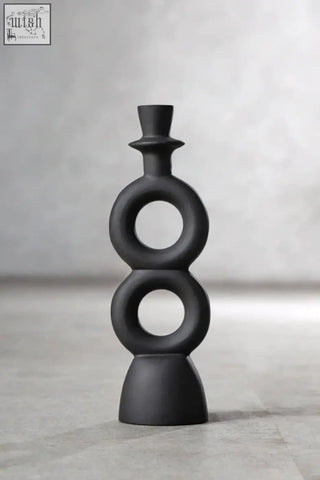 Black matte ceramic candle holder with stacked circular rings and top hat finial perfect for large black candle use