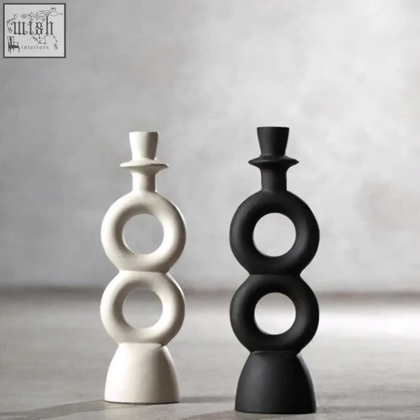 A sleek minimalist cream candle holder with stacked circular rings in matte white and black perfect for large cream candles