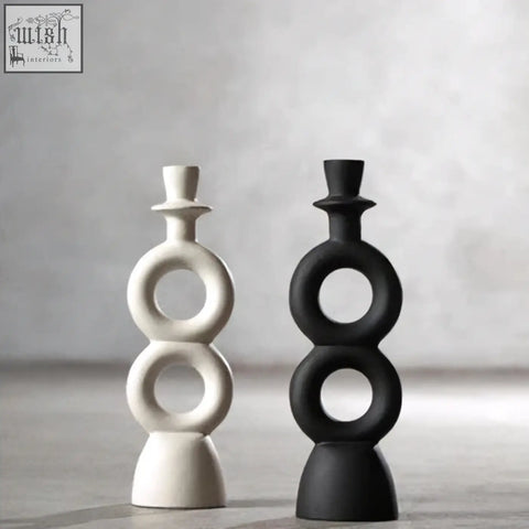 A sleek minimalist cream candle holder with stacked circular rings in matte white and black perfect for large cream candles