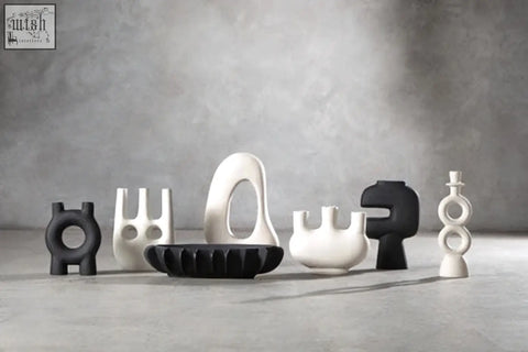 A sleek black ceramic candle holder with a glossy finish and oval cutout designed for large cream candles