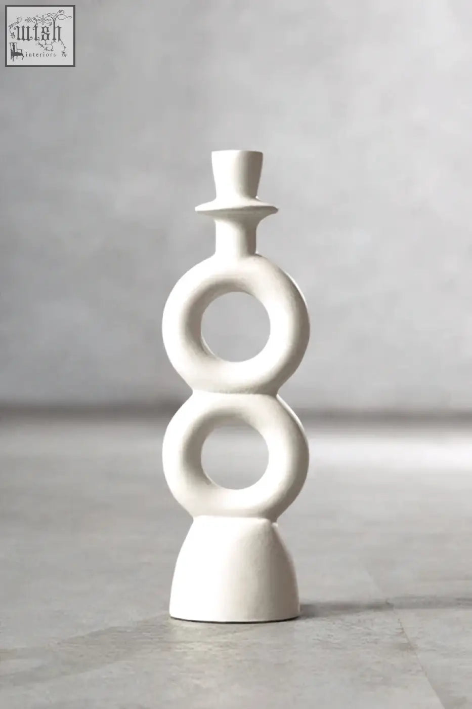 White ceramic abstract candle holder with stacked circular rings and top hat finial for large cream candle holder