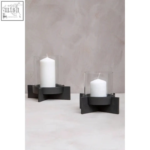 Hapax large matt black finish candle holder with black finish candle holders and clear glass sleeves cradling white candles