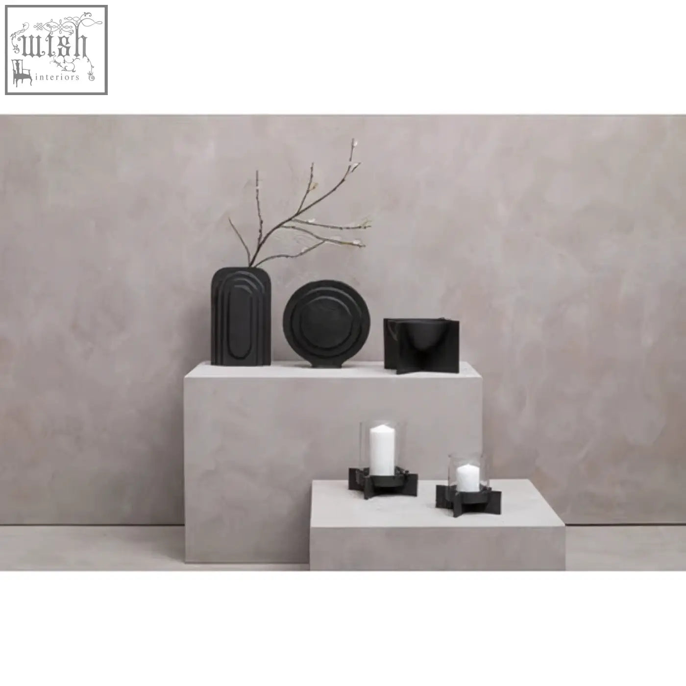 Black ceramic finish candle holder with sleek modern curves and a large matt black finish for candles