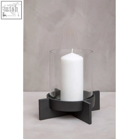 A sleek hapax large matt black finish candle holder with a geometric design and clear glass cylinder for pillar candles