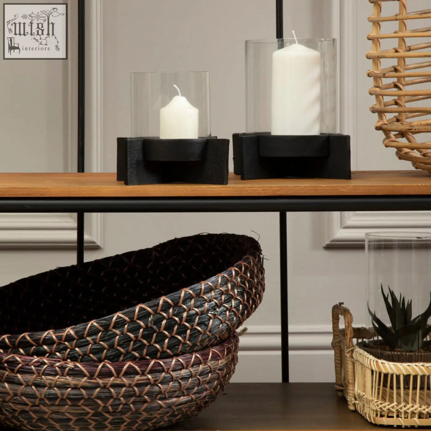 Two black finish candle holders with white pillar candles in clear glass cylinders for stylish home decor