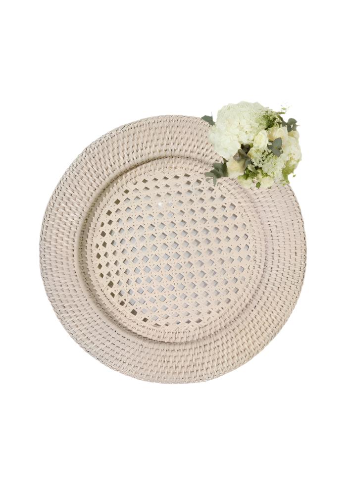 Beige woven rattan placemat with diamond pattern center and white floral decor from harbour island rattan charger set
