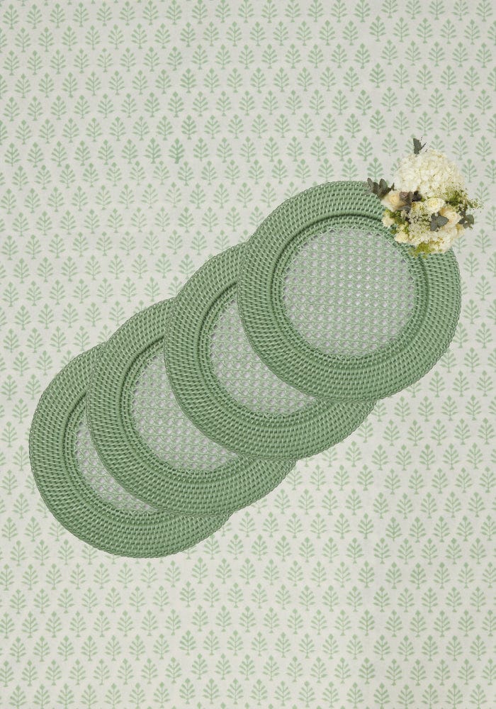 Set of four sage green woven placemats with delicate floral arrangement for harbour island round rattan charger green