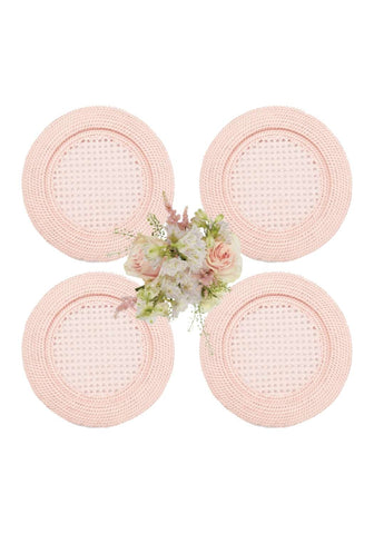 Set of four blush pink harbour island round rattan charger placemats with textured basket weave pattern