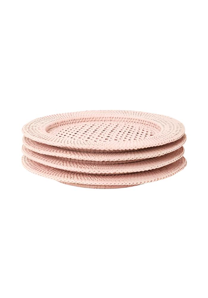 Set of four blush pink woven rattan coasters with a perforated center design for table protection and style